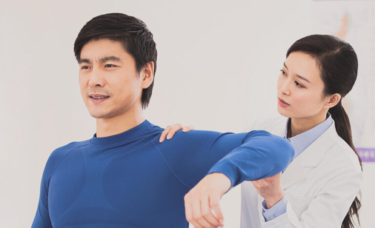 Female physician examining patient's arm